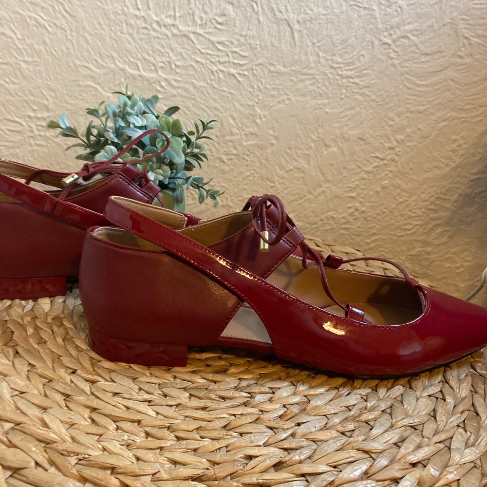 Red leather Calvin Klein flats with lace up detail